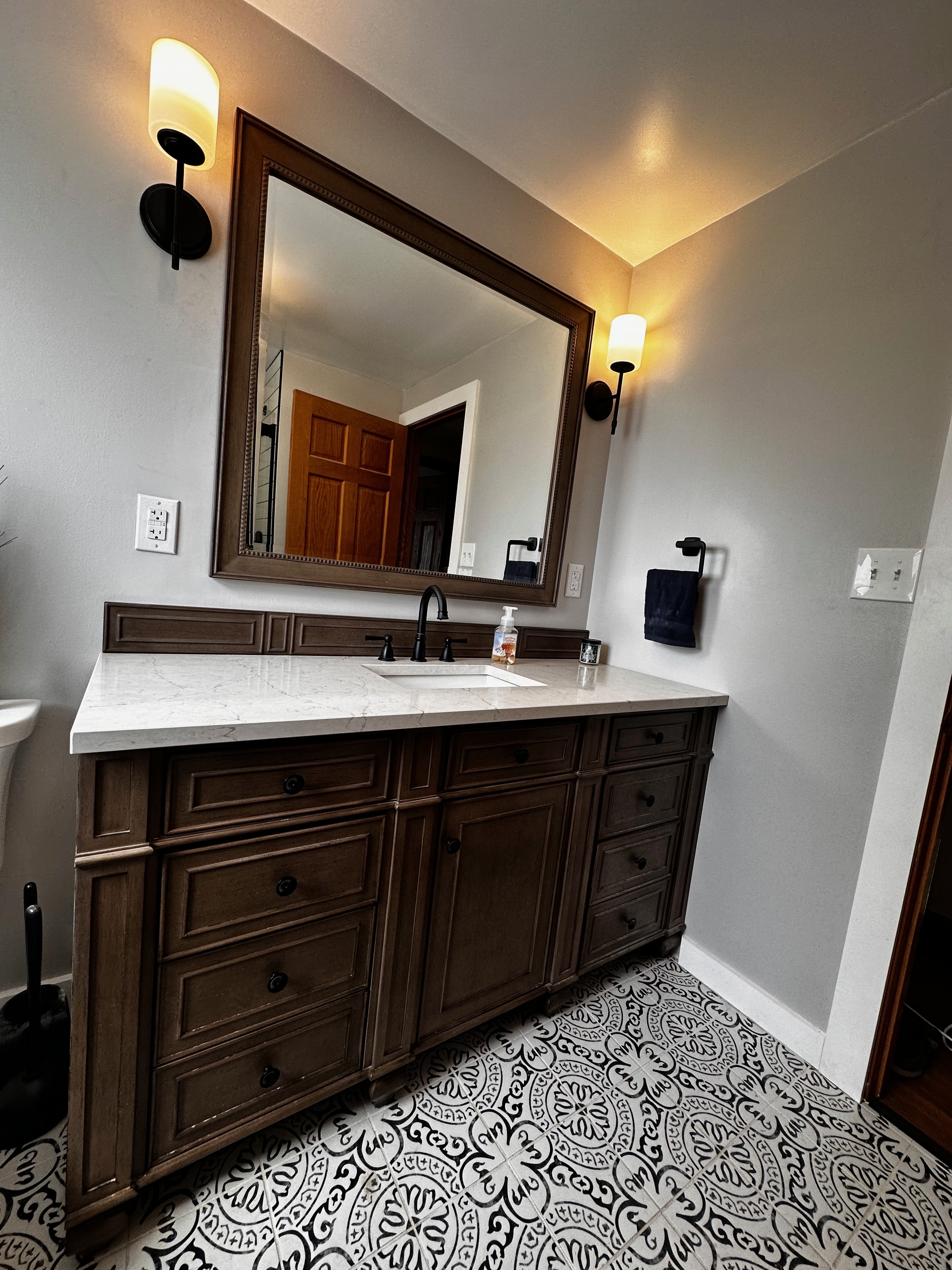 Bathroom vanity and patterned floor tile