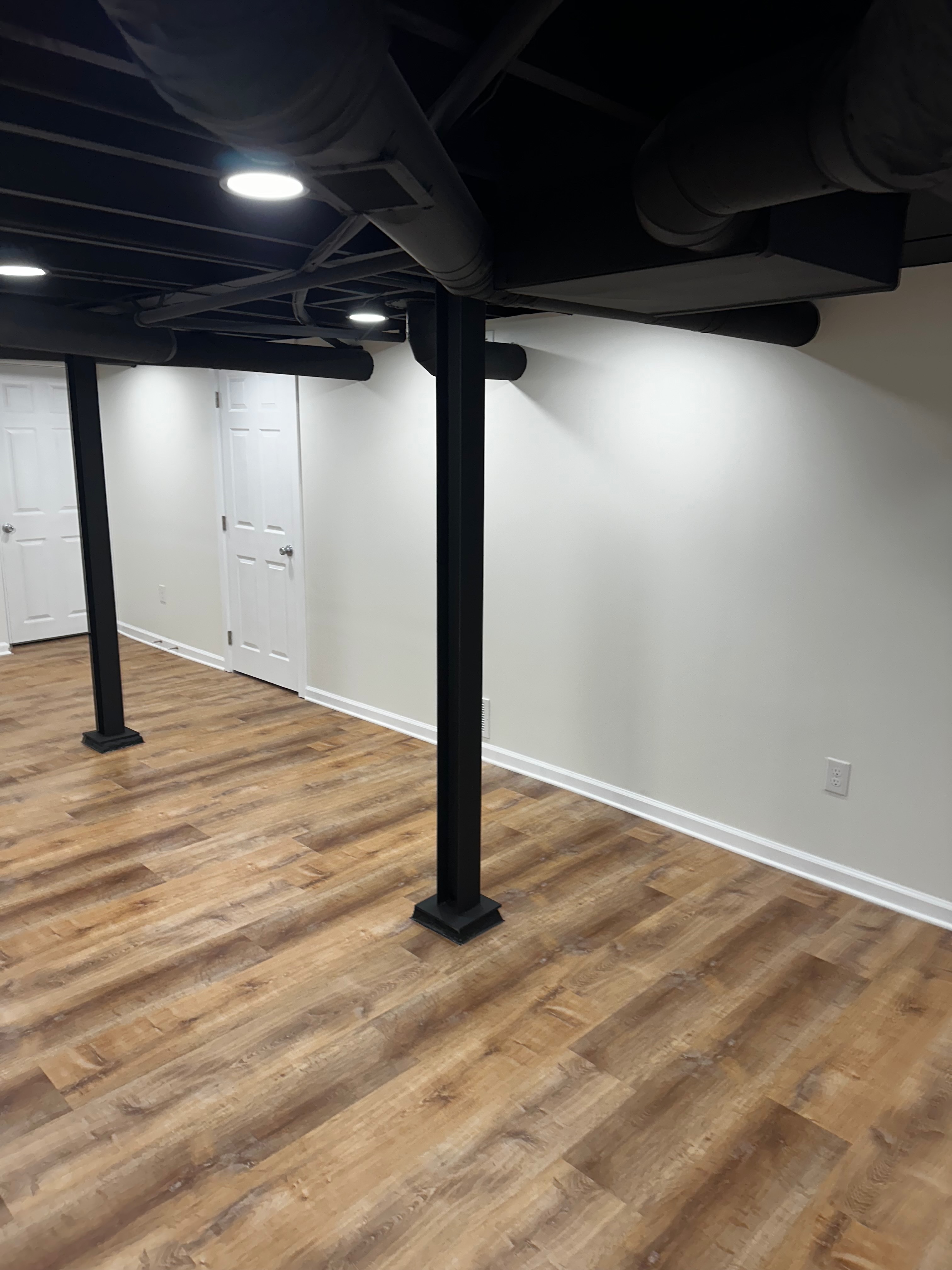 Alternate view across the finished basement gym area