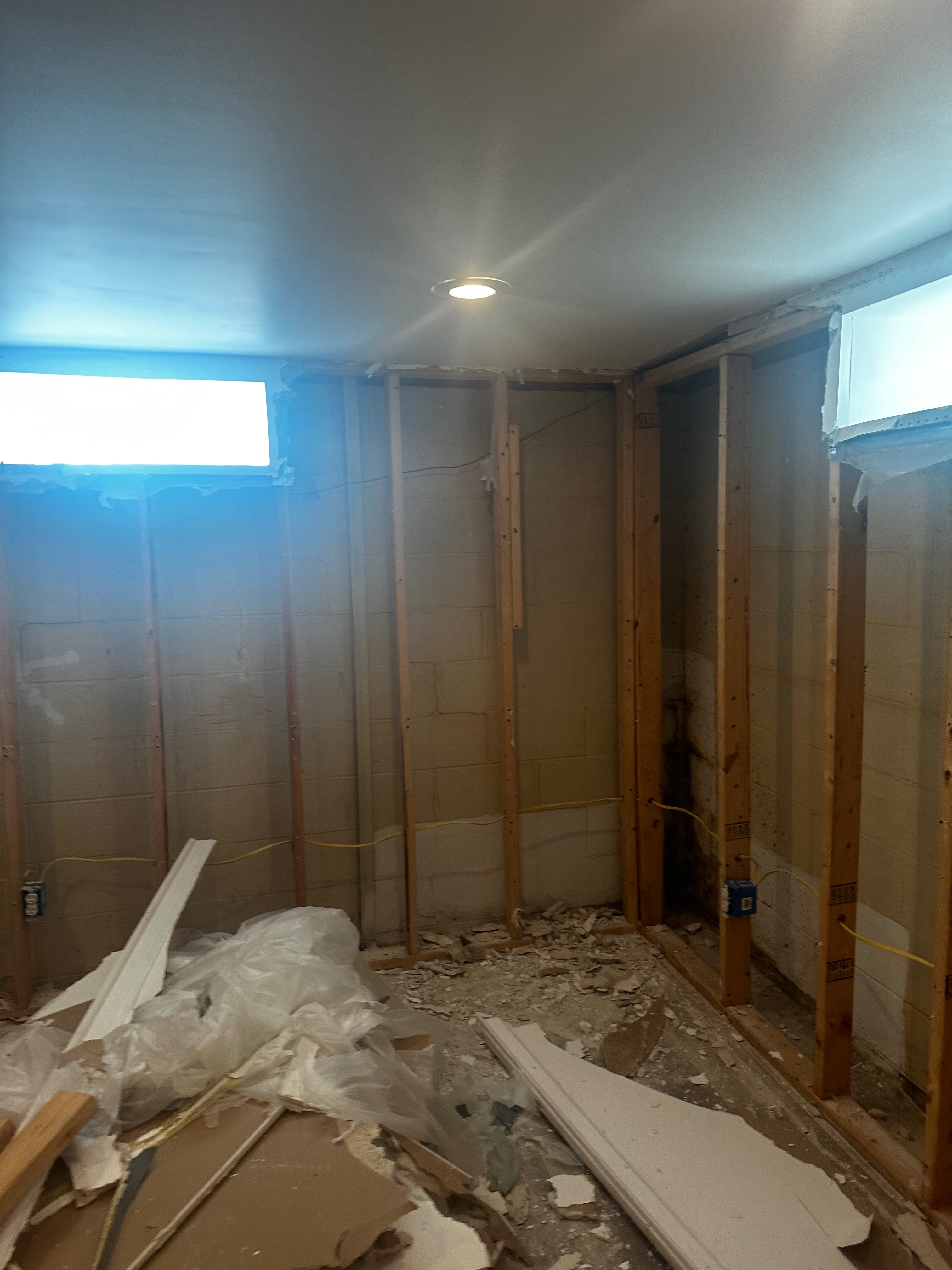 The same basement area before completion, with exposed framing and unfinished surfaces