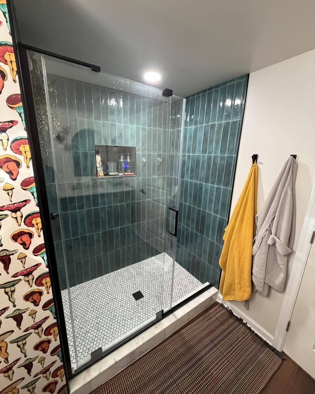 Green tile shower in the lower-level bathroom