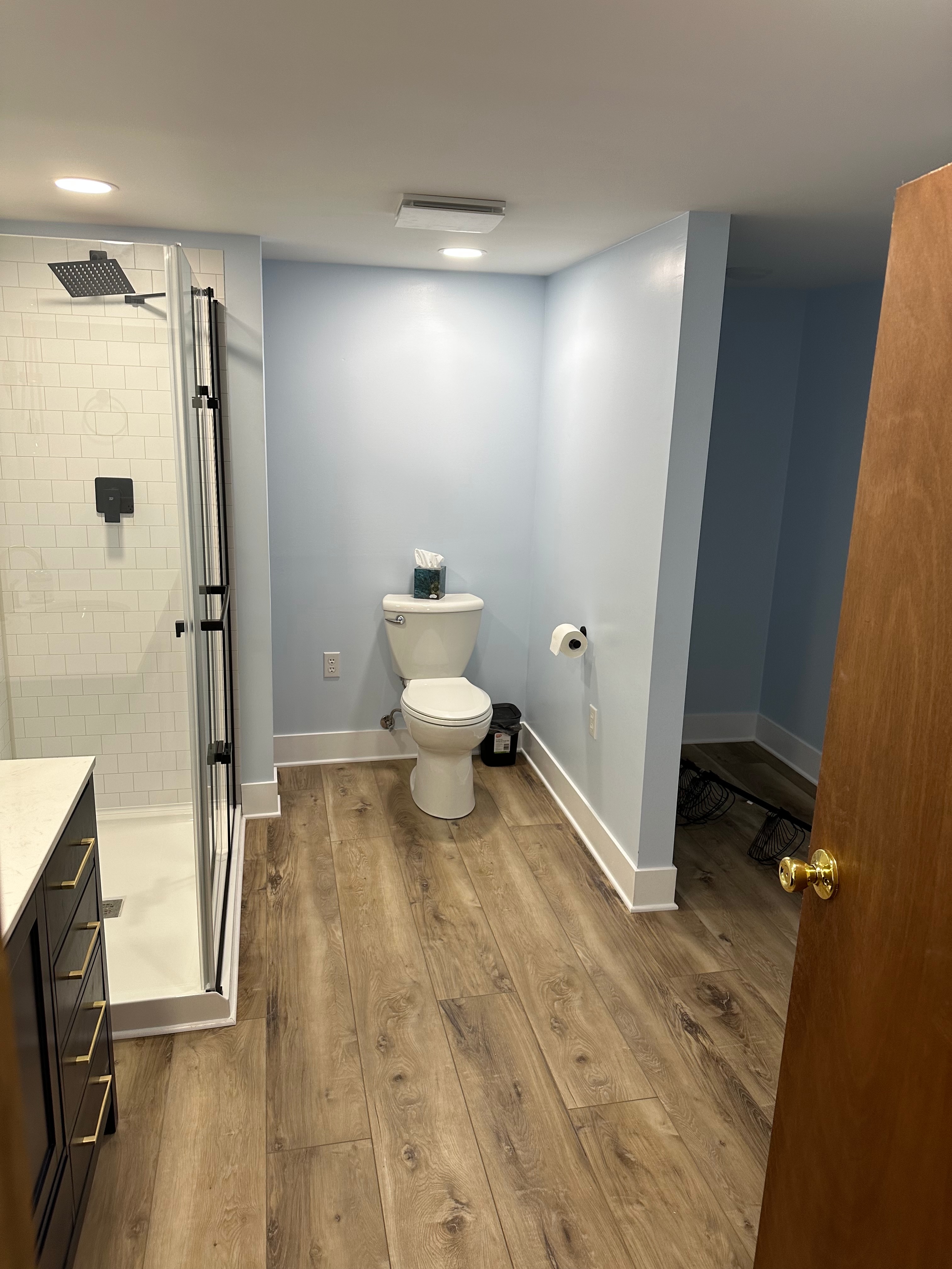 Bathroom floor continuing toward the adjoining room — finished