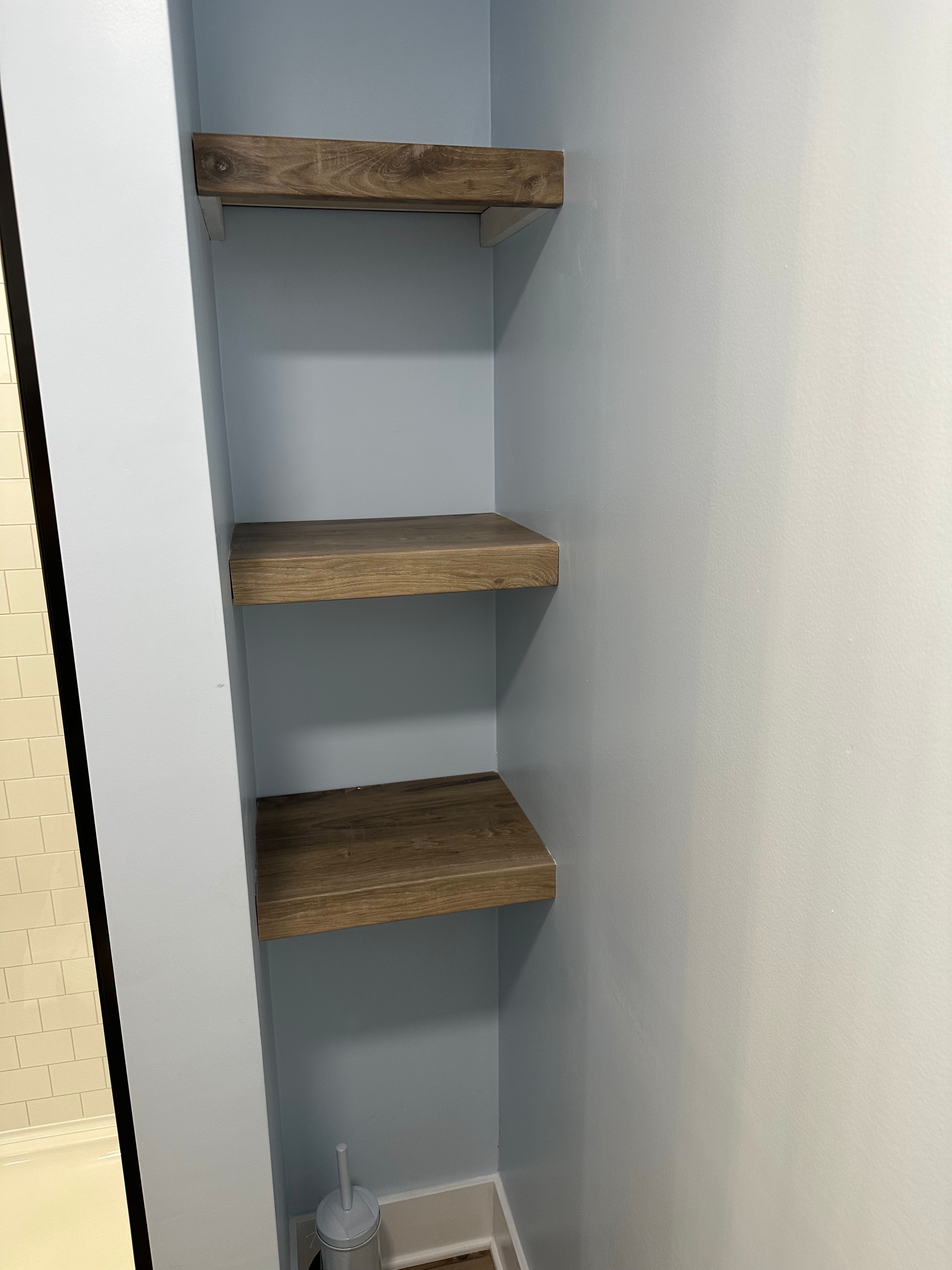 Built-in shelves beside the shower — finished